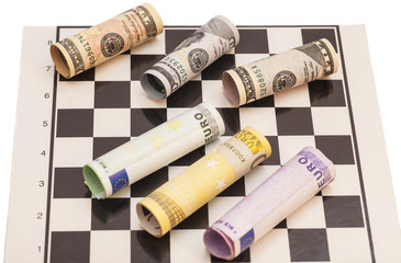 Dollars and Euro banknotes on chess board