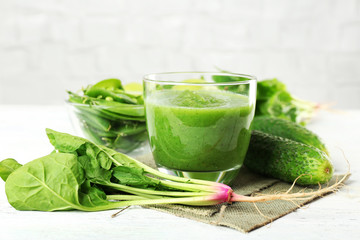 Healthy green smoothie on wooden table, closeup