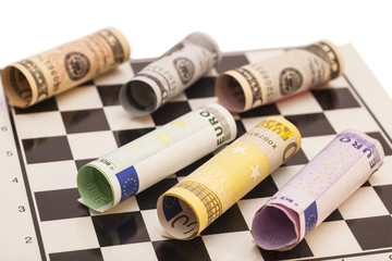 Dollars and Euro banknotes on chess board