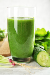 Healthy green smoothie on wooden table, closeup