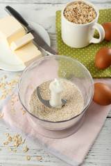 Ingredients for oatmeal cookies on wooden table, closeup