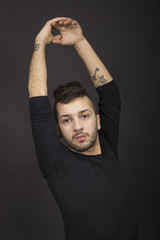 Male dancer practising , arm extented.