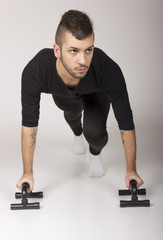 Obraz premium Dancer exercising push ups, on white background.