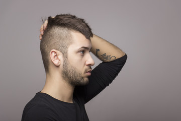 Tattooed boy with mohawk.