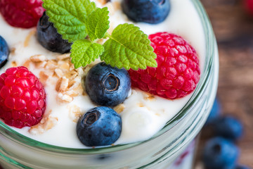 Detail of Yogurt with Fresh Berries on Woden Table