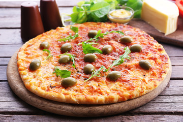 Pizza on wooden table, closeup