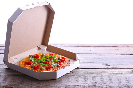 Pizza In Box On Wooden Table Isolated On White