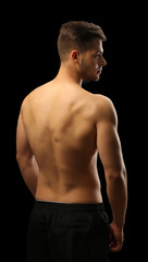 Fototapeta premium Muscle young man on dark background