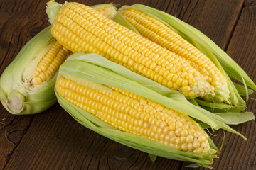 Corn on old wooden background