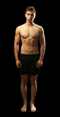 Muscle young man on dark background