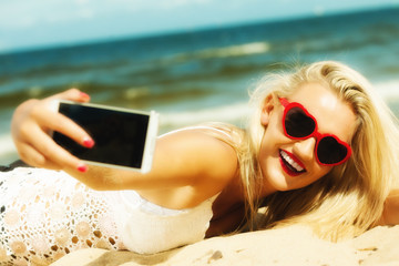 Happy girl taking self picture with smartphone