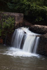 Mountain water cascading by rocks
