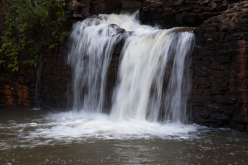 Fototapeta premium Mountain water cascading by rocks
