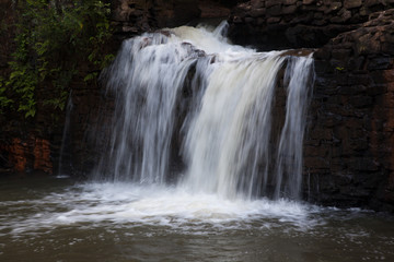 Mountain water cascading by rocks