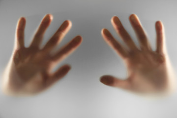 Hands silhouettes behind glass foreground