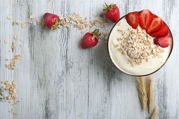 Healthy homemade oatmeal on wooden table, close up