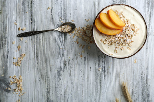 Healthy homemade oatmeal on wooden table, close up