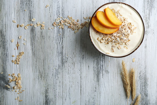 Healthy homemade oatmeal on wooden table, close up