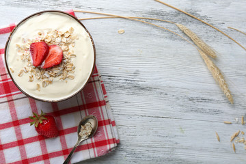 Healthy homemade oatmeal on wooden table, close up