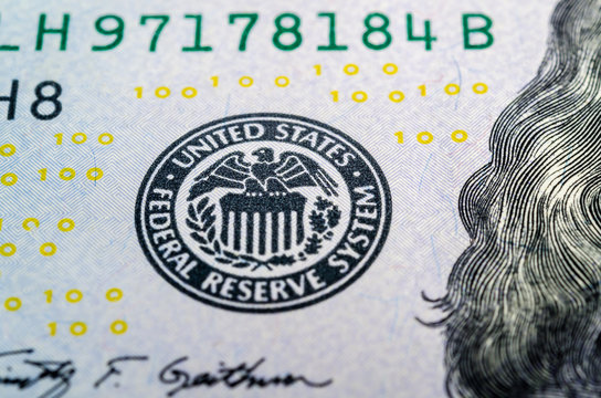 Federal reserve system symbol on hundred dollar bill closeup mac