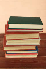 Stack of books on wooden background