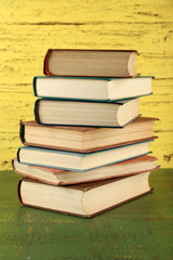 Stack of books on wooden background