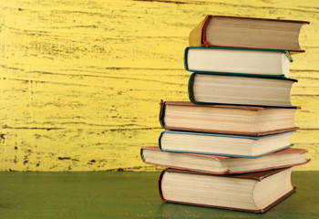 Stack of books on wooden background