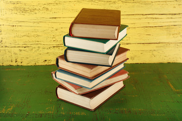 Stack of books on wooden background