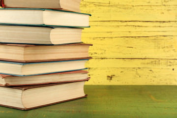 Stack of books on wooden background