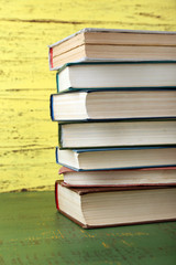 Stack of books on wooden background