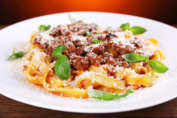 Pasta Bolognese with parmesan and basil on table close up