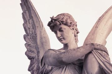 Fototapeta na wymiar Vintage image of a sad angel on a cemetery