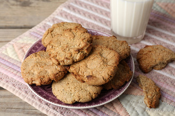 Homemade cookies and glass of milk on table close up