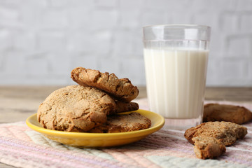 Homemade cookies and glass of milk on table close up
