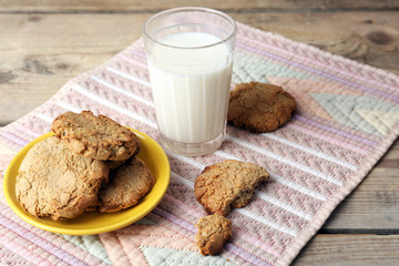 Homemade cookies and glass of milk on table close up