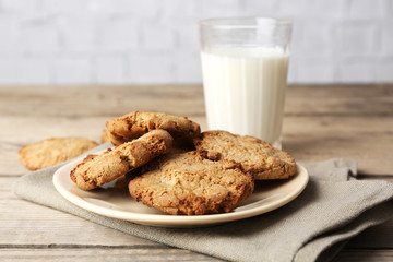 Homemade cookies and glass of milk on table close up