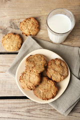 Homemade cookies and glass of milk on table close up
