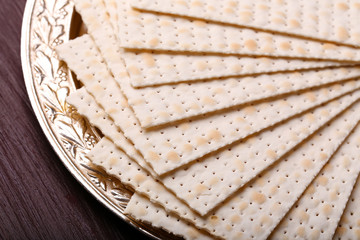 Matzo for Passover on metal tray on table close up