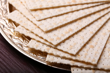 Matzo for Passover on metal tray on table close up