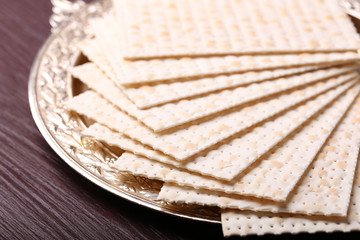 Matzo for Passover on metal tray on table close up