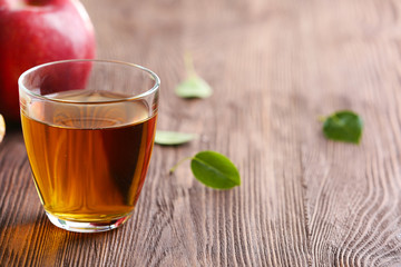 Glass of apple juice and fruits on table close up