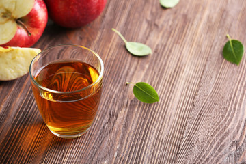 Glass of apple juice and fruits on table close up