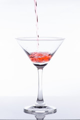 orange cocktail in glass isolated on white background