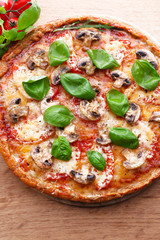 Tasty pizza with vegetables and basil on table close up