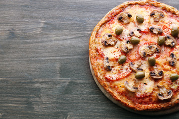 Tasty pizza with vegetables on wooden background