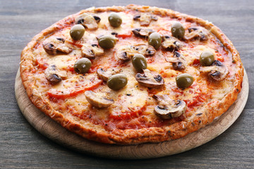 Tasty pizza with vegetables on wooden background