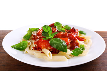 Pasta with tomato sauce and basil on light background