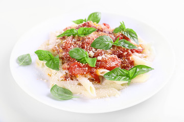 Pasta with tomato sauce and basil isolated on white
