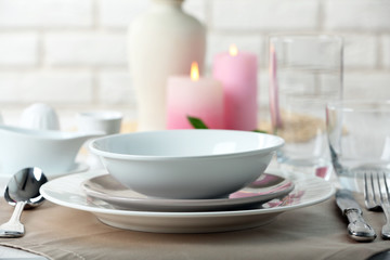 Beautiful table setting with candles close up