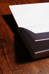 Blank book on wooden background